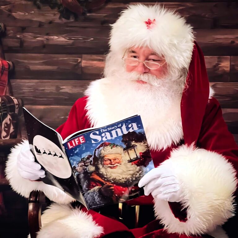 Santa Claus reading a LIFE magazine that has an image of Santa on the cover.